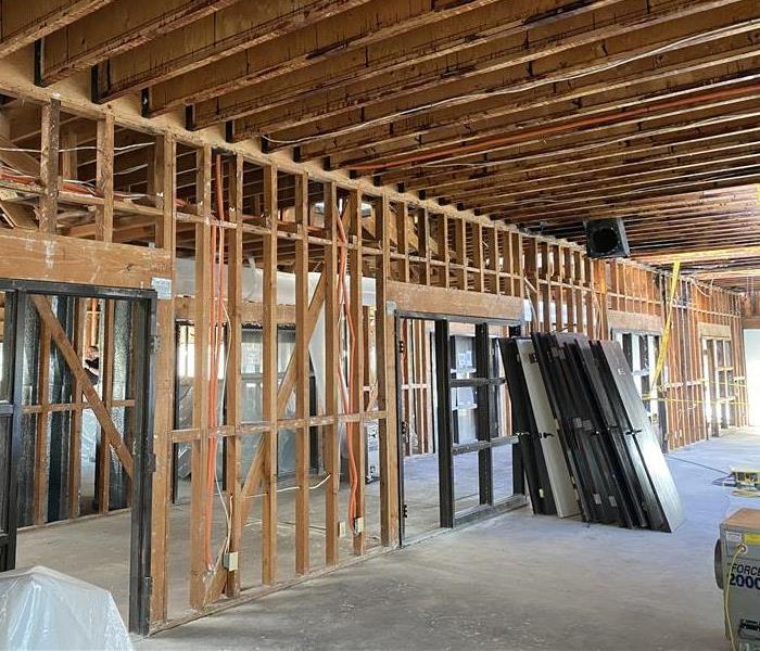 commercial building loss with walls stripped revealing framework beneath